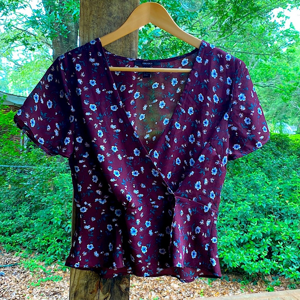 Sheer blouse with wrap around front attached by buttons. Deep V for flirty vibe!